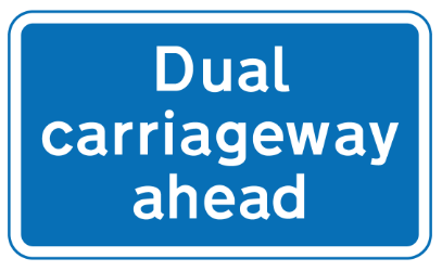 A section of dual carriageway road begins directly ahead